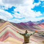 Rainbow Mountain Man Arms Raised